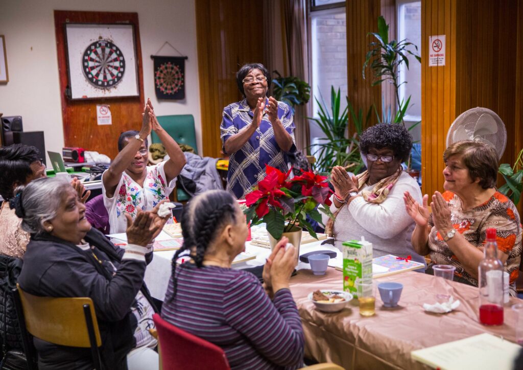 People at The Albany Meet Me christmas party clapping hands together