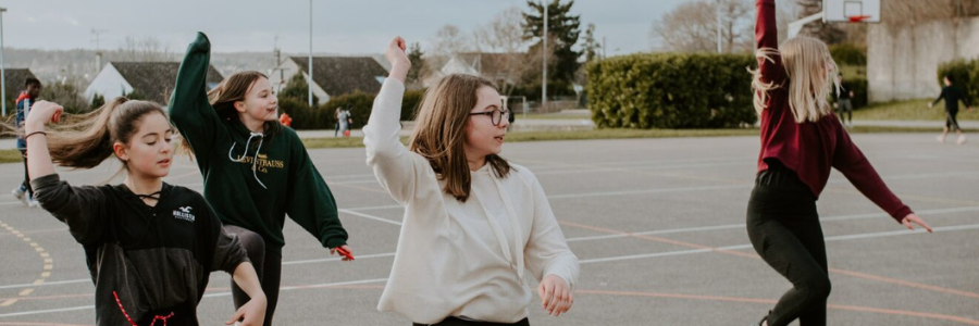 A group of girls dancing outside