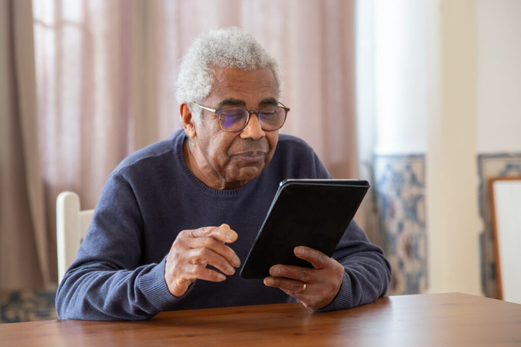 A man looking intently at his ipad