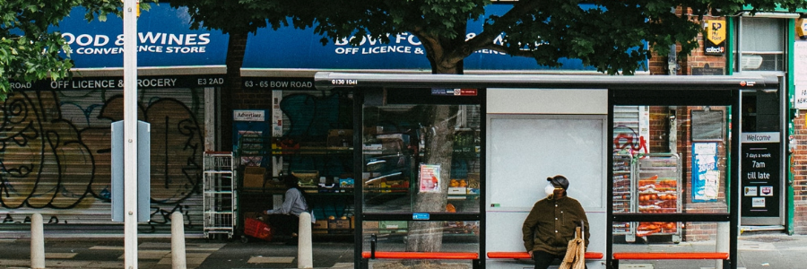 A man sitting at a bus stop