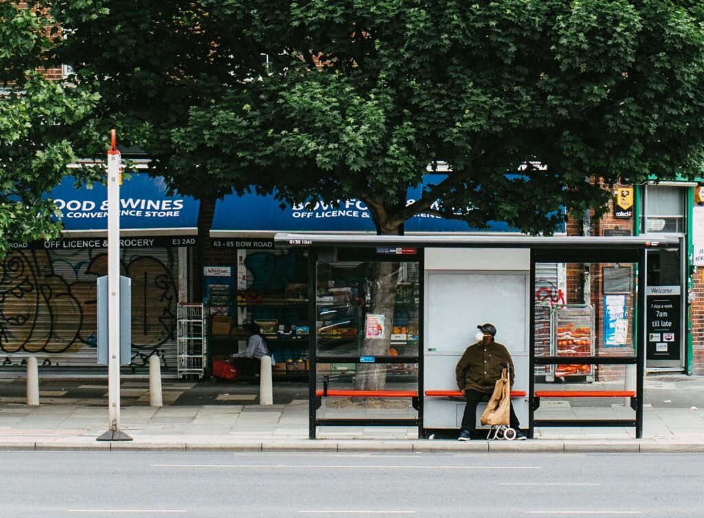 A man sitting at an empty bus stop