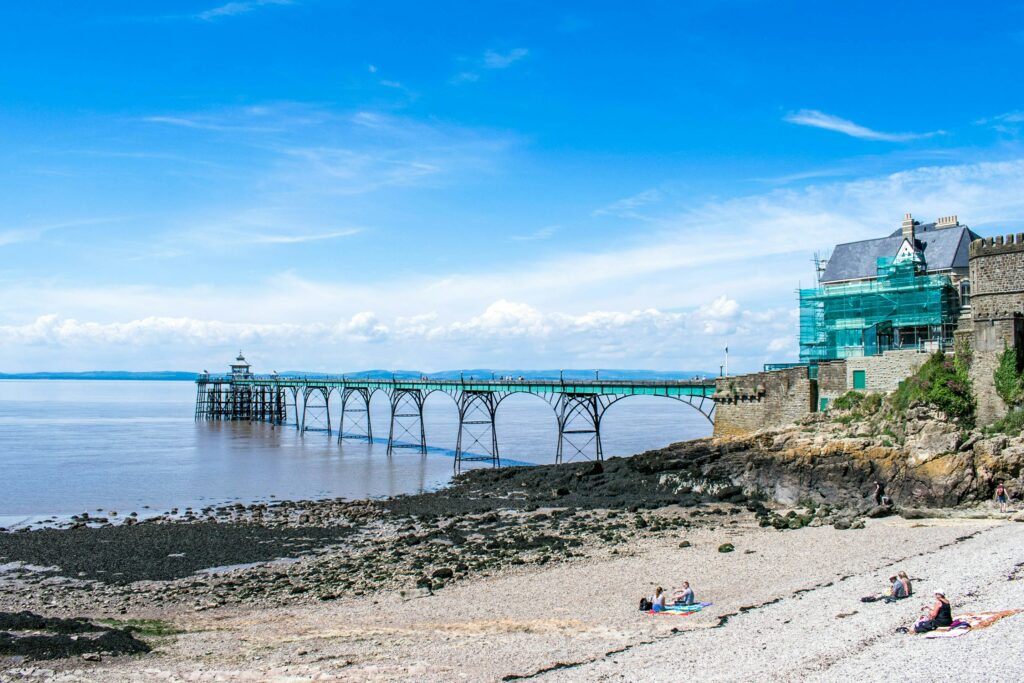 Photograph of Clevedon Pier during the daytime undergoing maintenance, wrapped in green netting