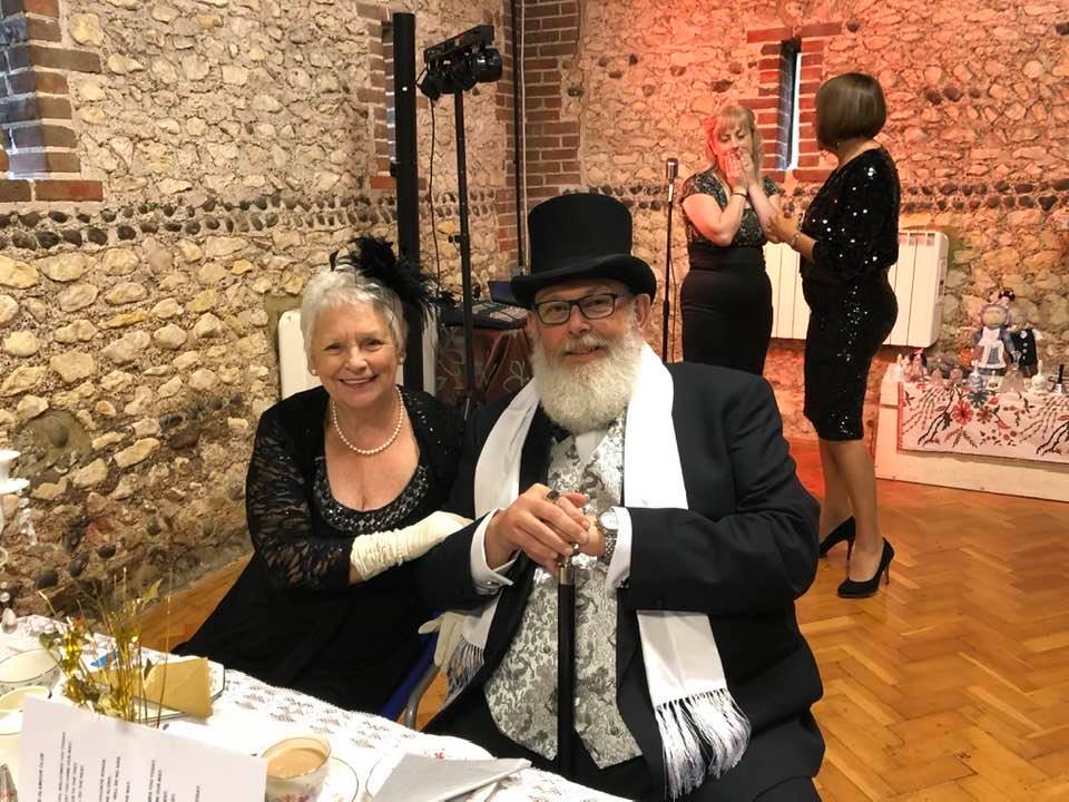 A man and woman dressed in evening wear for a Glamour Club events.