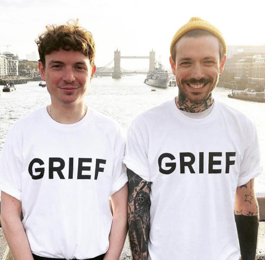 ben & Jack smiling wearing white t shirts with the word 'grief' written across the front.