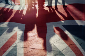 UK flag and shadows of people