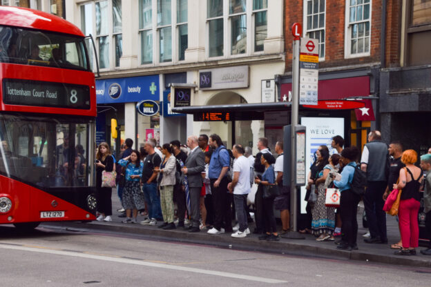 People waiting at a bus stop in London, UK