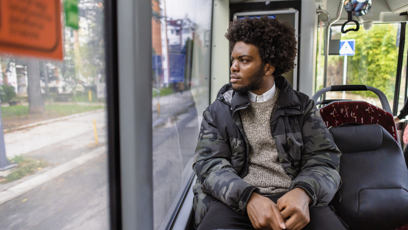 Man sitting on public transport bus alone