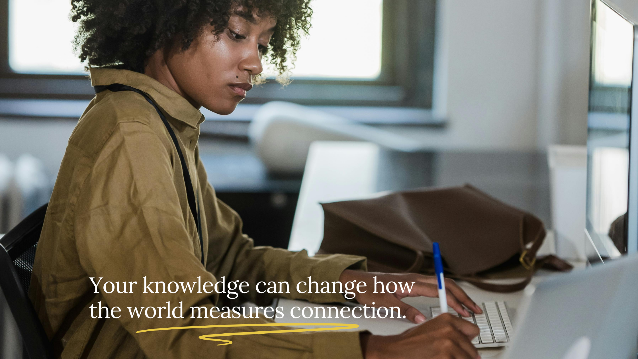 woman sitting at a desk working with the caption 'your knowledge can change how the world measures connection'