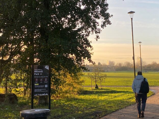 landscape photo of man walking in a london park