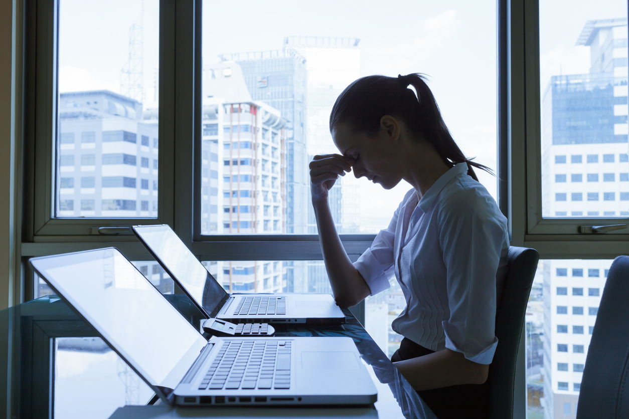 Stressed young business woman in the office.