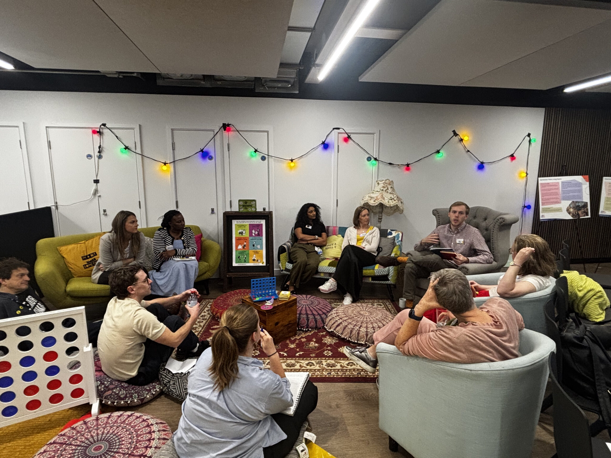 people sitting on the floor and chairs in the mock living room