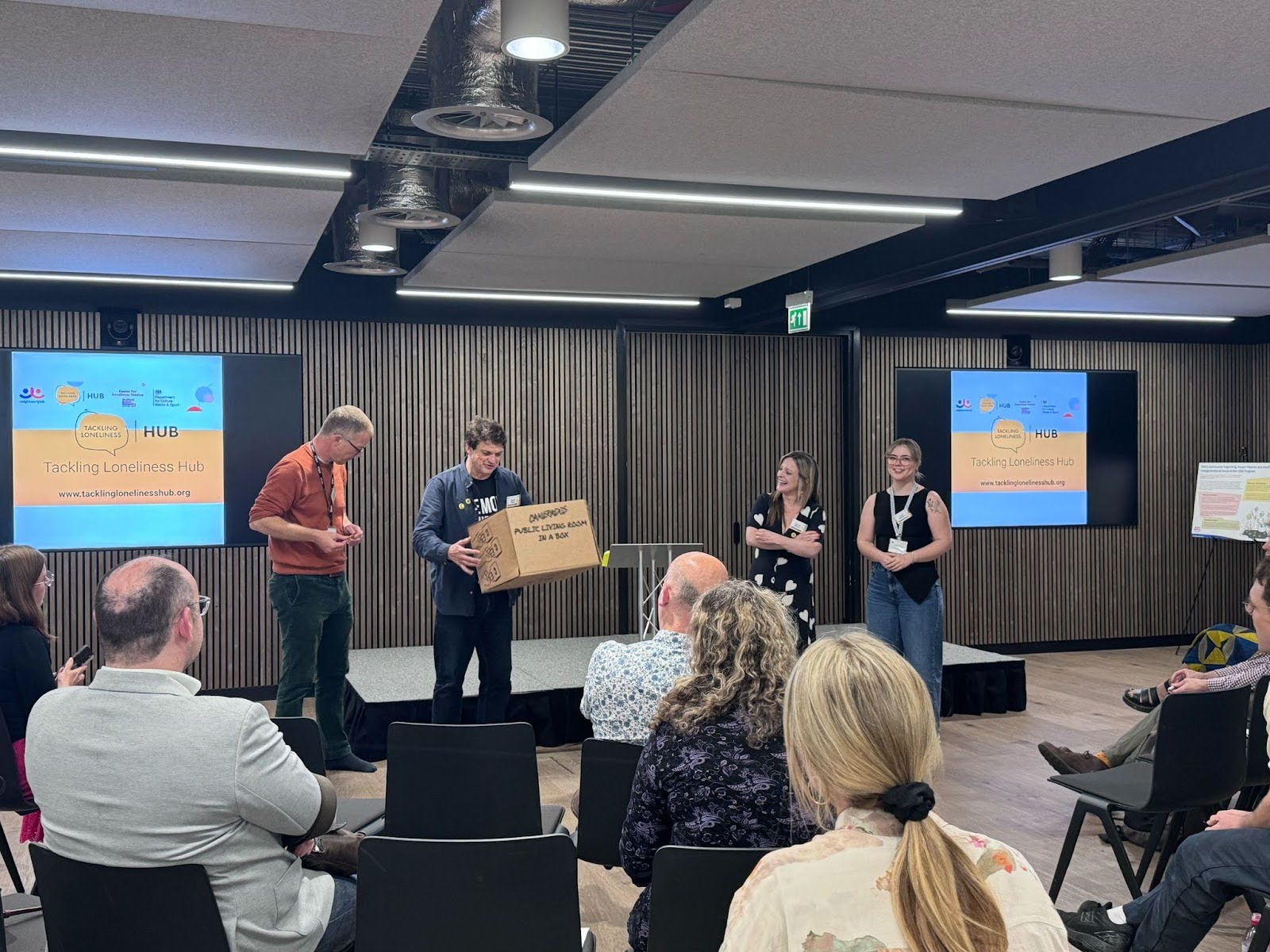 Maff Potts presents the living room in a box to audience