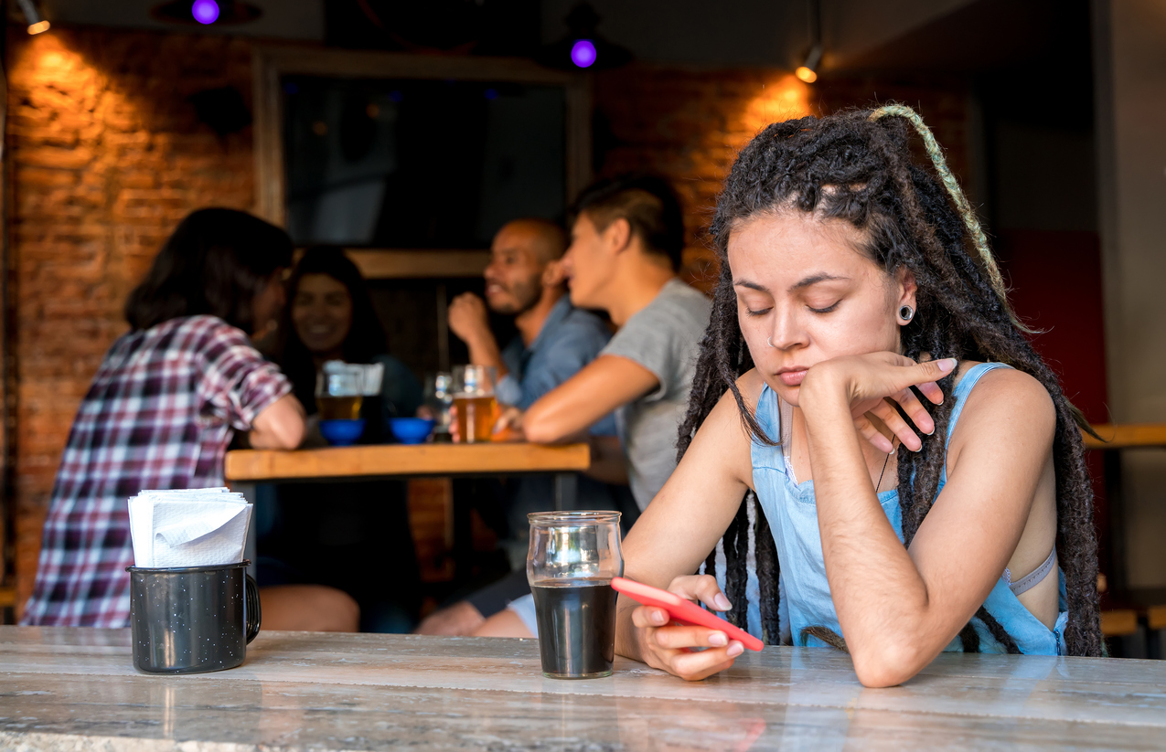 young lady sitting alone in a pub